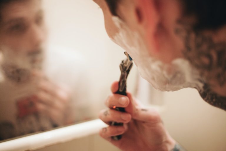 Man shaving in a bathroom